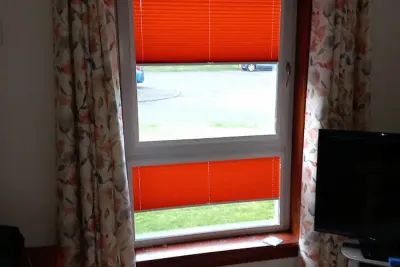 Made-to-measure curtains paired with blinds in an Edinburgh living room
