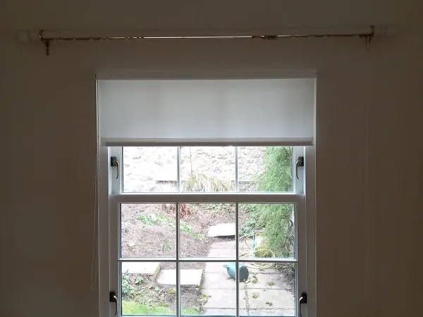 White roller blind on a single sash window