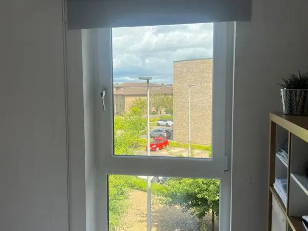 Retracted roller blind in a bedroom showing clean lines