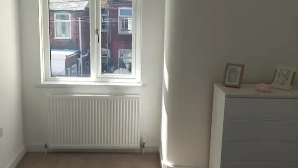 White blackout roller blind fitted in an Edinburgh bedroom