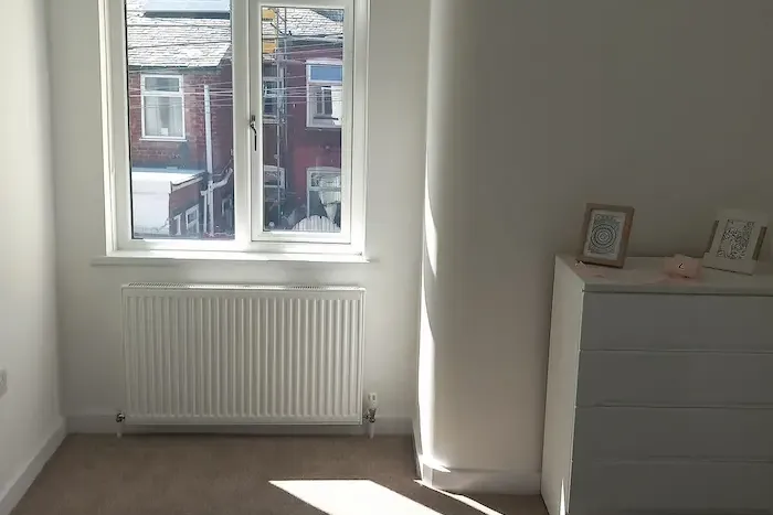 White blackout roller blind fitted in an Edinburgh bedroom