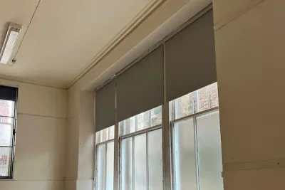 Grey commercial roller blinds in an Edinburgh building