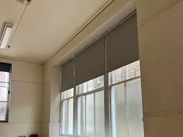 Grey commercial roller blinds in an Edinburgh building