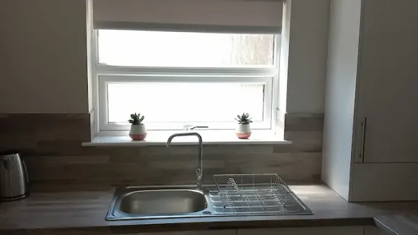 Roller blind fitted above a kitchen sink window