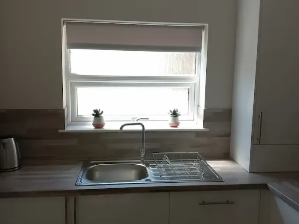 Roller blind fitted above a kitchen sink window