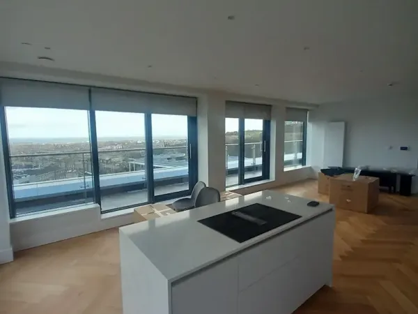 Roller blinds in a modern Edinburgh penthouse kitchen with panoramic city views
