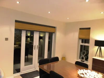 Gold and charcoal roman blinds in a dining room