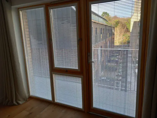 Wooden venetian blinds on patio doors